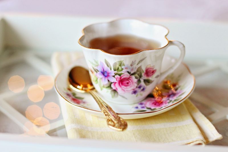Cup of tea in a floral print teacup.